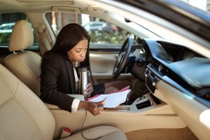 Woman view papers in car | Bowie, MD